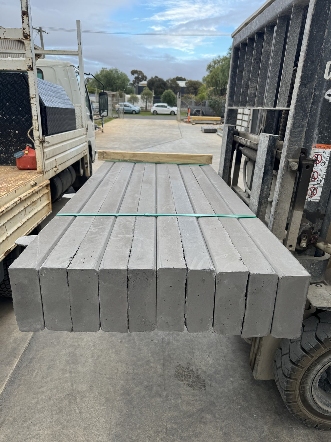 Bundle of plain concrete sleepers handled with a forklift
