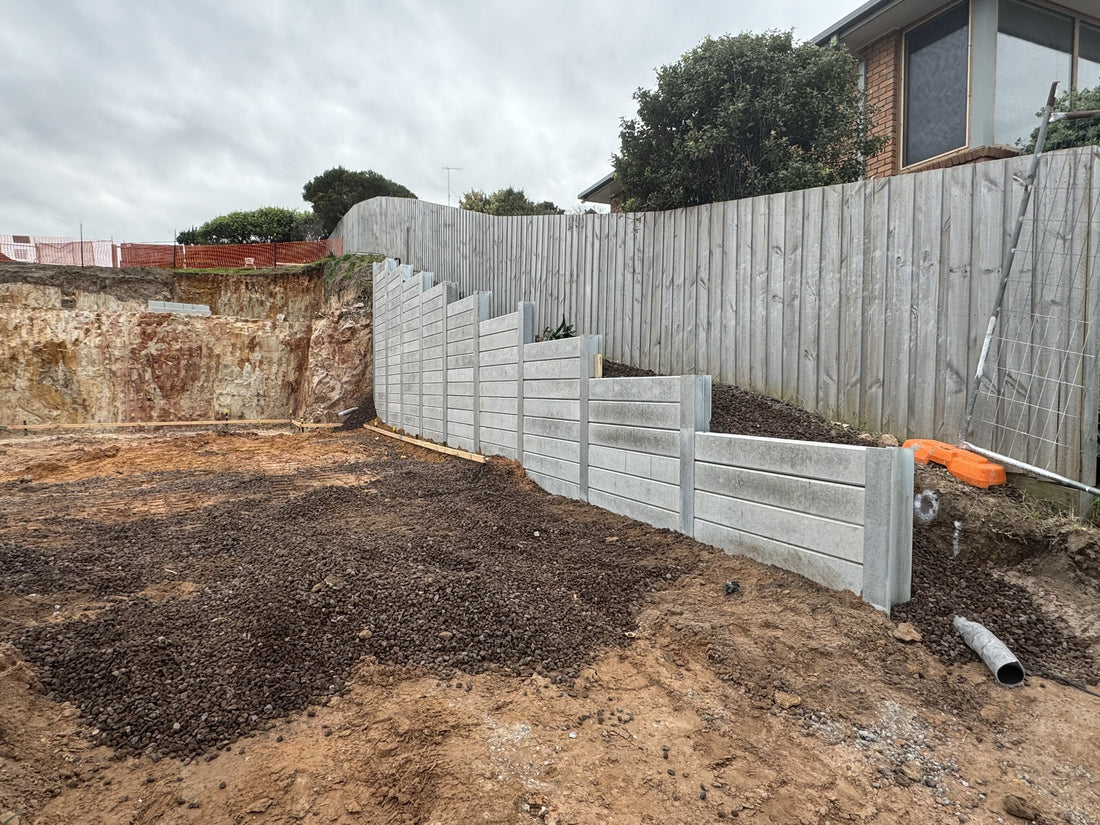 Plain concrete sleeper retaining wall with a stepped profile