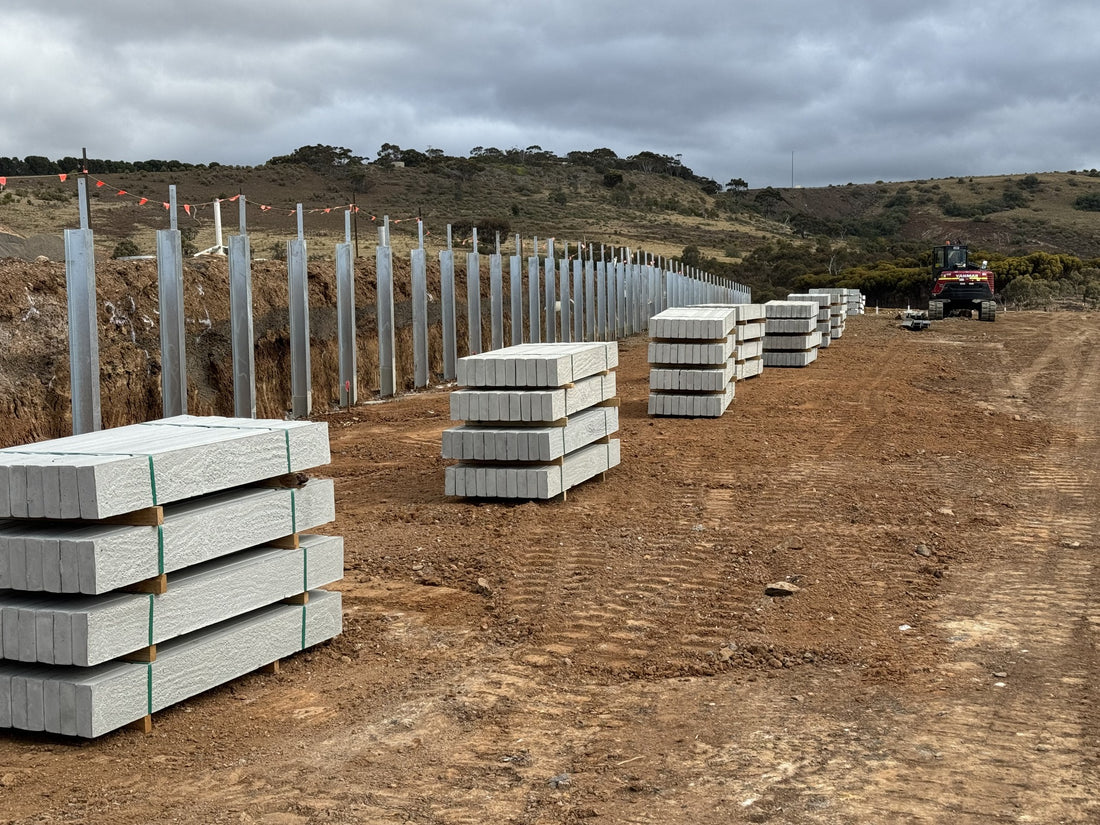 Concrete sleeper bundles delivered along a retaining wall at a Bacchus Marsh development